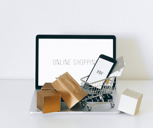 Online shopping concept with laptop, cart, and payment phone – E-Commerce Development Company in Kochi