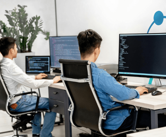 Web Development Company In Kochi team working on custom software and website development projects in a modern office environment.